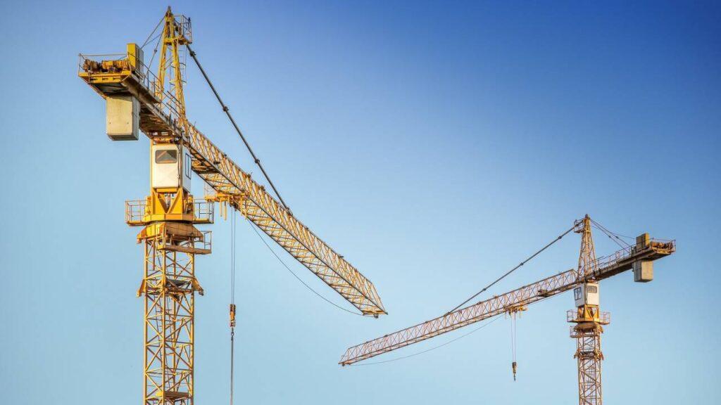 A photo of yellow construction cranes