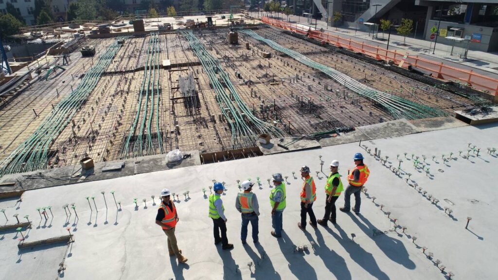 Several workers looking at a new construction site 