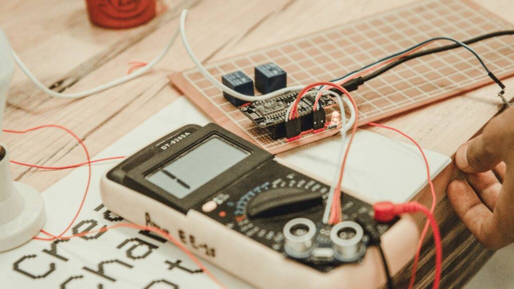 A close-up photo of a person making use of an advanced multimeter 