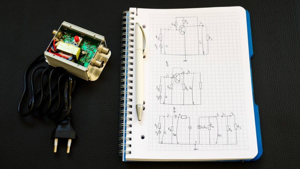 A notebook with sketches next to a machine part