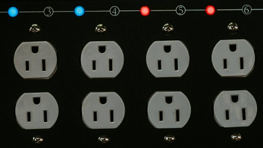 Eight outlets with red and blue lights above them